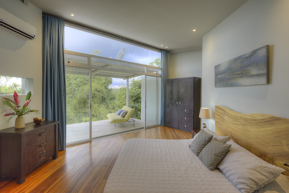 Master bedroom with private balcony and jungle views