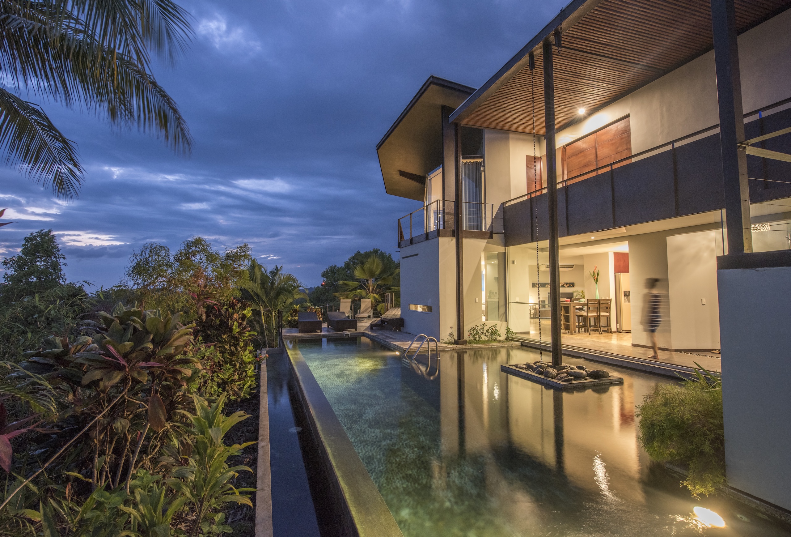 Tropical Villa at night with illuminated pool